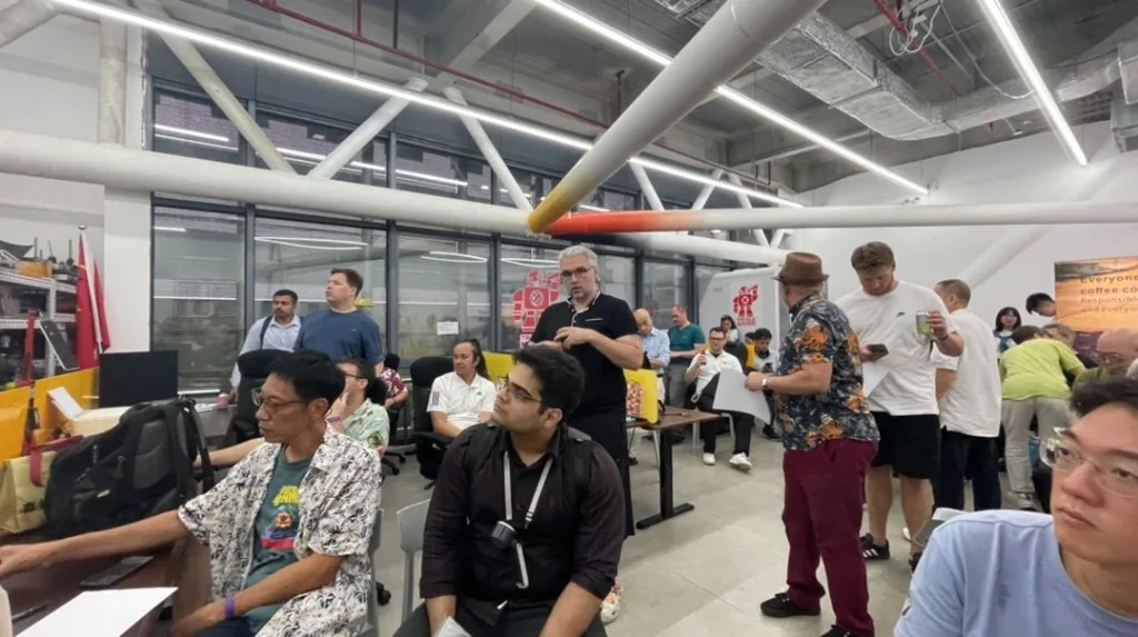 TroubleMaker Shenzhen Ceremony with entrepreneurs and digital nomads gathered in a startup workspace