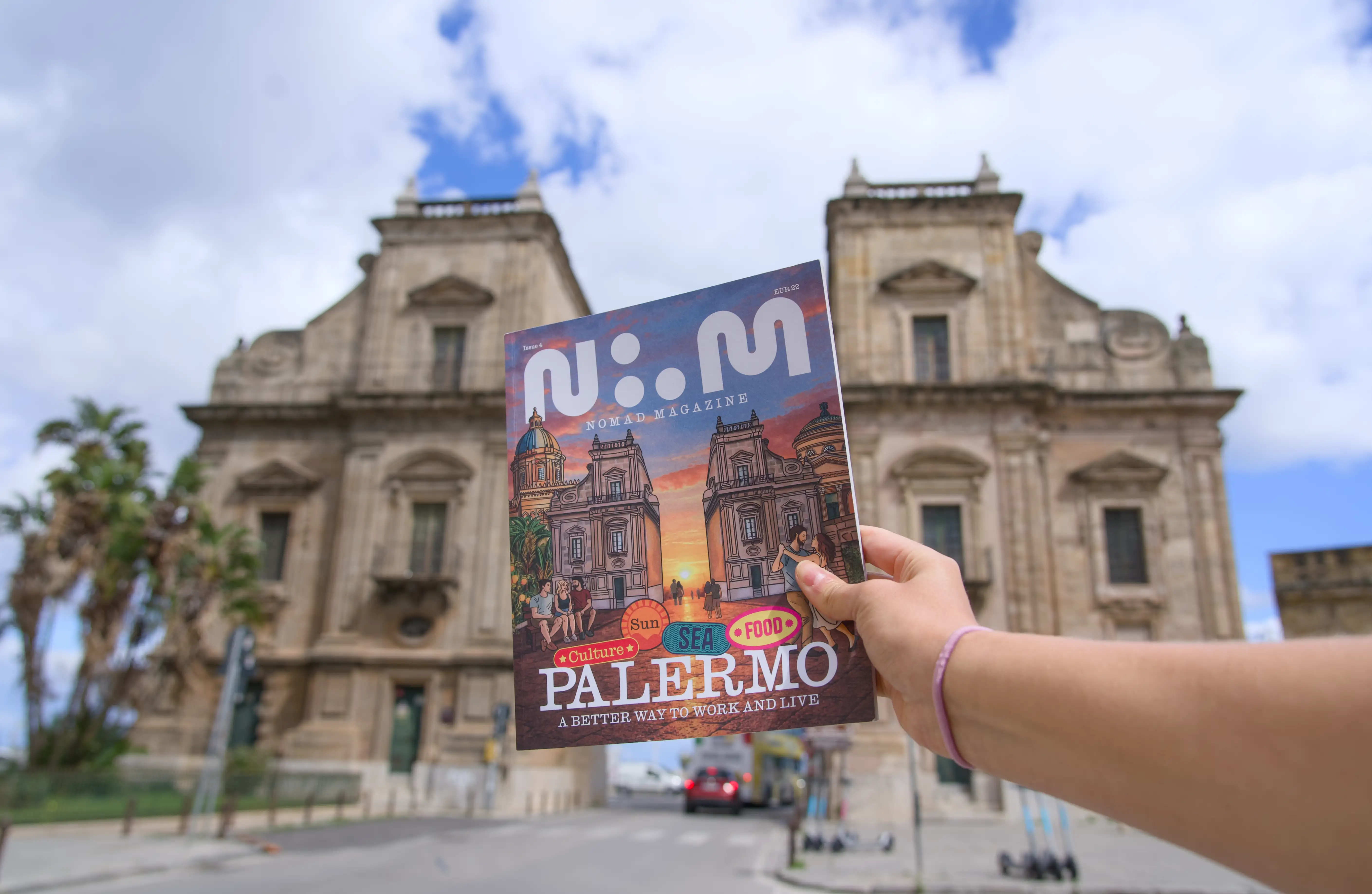 Nomad Magazine Edition Four held up in front of a Palermo church